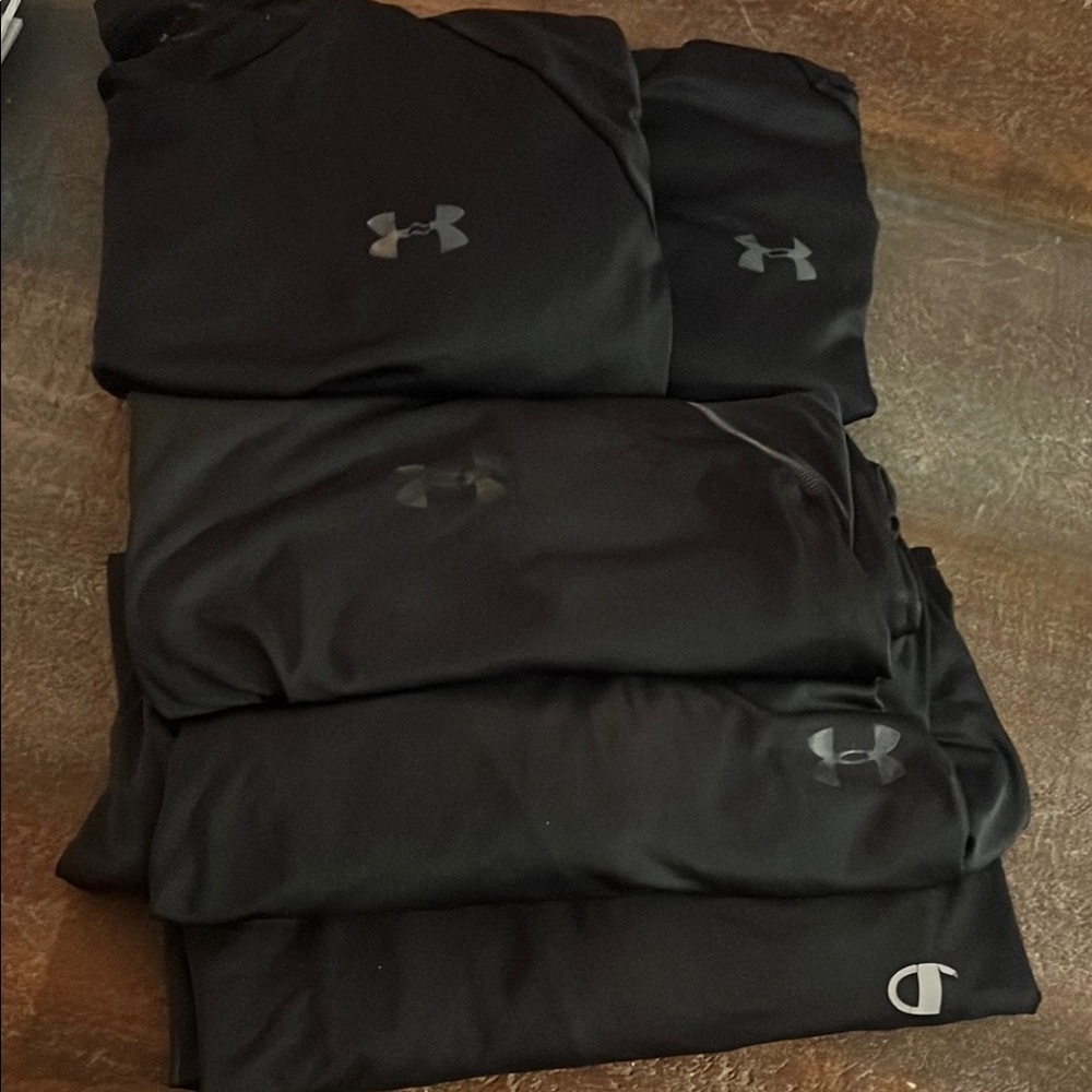Under Armour Black Athletic Dri fit shirts.  Lot of 4 UA plus 1 Champion in